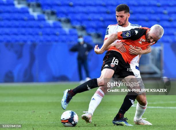 Lorient's French midfielder Fabien Lemoine is challenged by Lyon's French midfielder Houssem Aouar during the French L1 football match between...