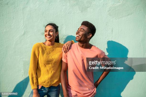portrait of two smiling couple looking away. - young adult imagens e fotografias de stock