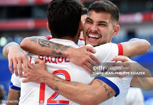 Lyon's players celebrates after scoring during the French L1 football match between Lyon and Lorient on May 8 at the Groupama stadium in...