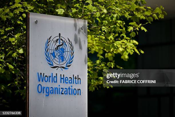 Picture taken on May 8, 2021 shows a sign of the World Health Organization at the entrance of their headquarters in Geneva amid the Covid-19...