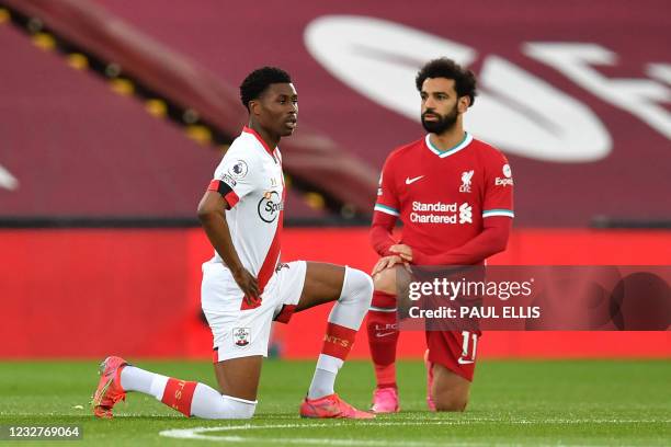 Southampton's English midfielder Nathan Tella and Liverpool's Egyptian midfielder Mohamed Salah 'take a knee' in support of the No Room For Racism...