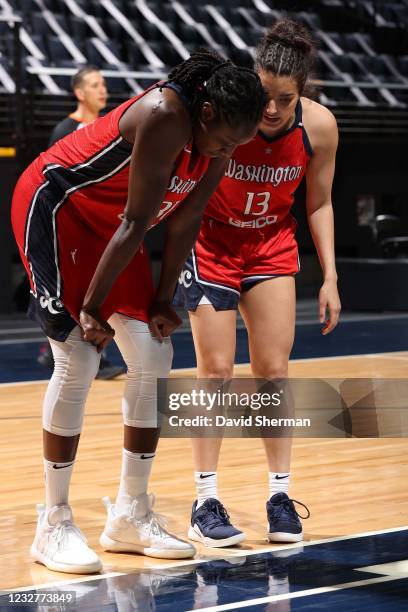 Aislinn Konig and Tina Charles of the Washington Mystics talk during the game against the Minnesota Lynx on May 8, 2021 at Target Center in...
