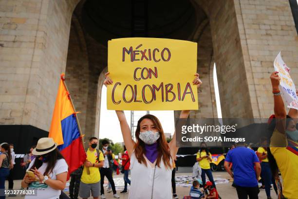 Colombian citizen holds a placard saying "Mexico with Colombia" during a protest in support of the National Strike in Colombia. Several...
