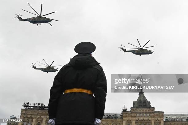 Russian military helicopters fly over Red Square during the Victory Day military parade in Moscow on May 9, 2021. - Russia celebrates the 76th...