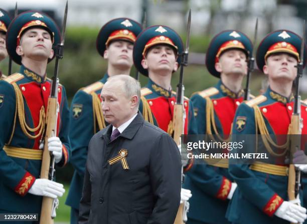 Russian President Vladimir Putin attends a flower-laying ceremony at the Tomb of the Unknown Soldier after the Victory Day military parade in Moscow...