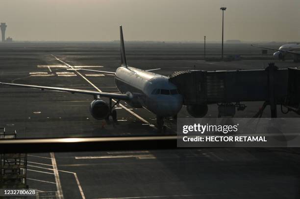 An aircraft is parked at Pudong International Airport in Shanghai, on May 9, 2021.