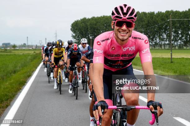 Team Ineos rider Italy's Filippo Ganna, wearing the overall leader's pink jersey, reacts as he competes in the second stage of the Giro d'Italia 2021...