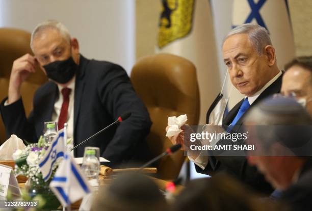 Israel's Prime Minister Benjamin Netanyahu and Defence Minister Benny Gantz , both wearing masks for protection against the COVID-19 pandemic, attend...