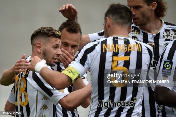 Angers' Algerian forward Farid El Melali celebrates with teammates after scoring during the French L1 football match between Angers SCO and Dijon...