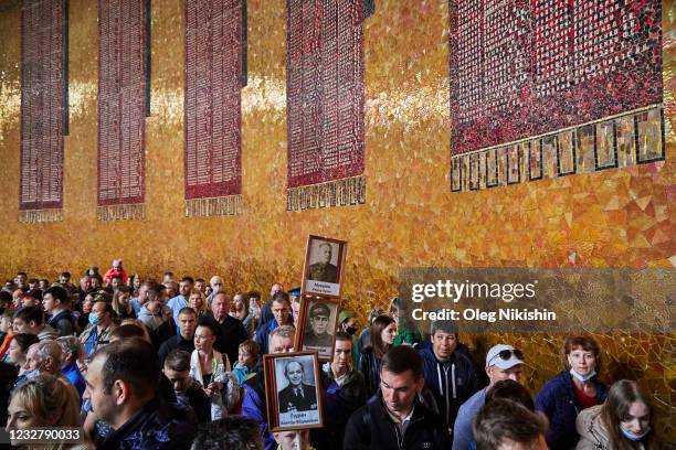 People at the Motherland Calls monument mark the 76th anniversary of the victory over Nazi Germany in World War II on May 9, 2021 in Volgograd,...