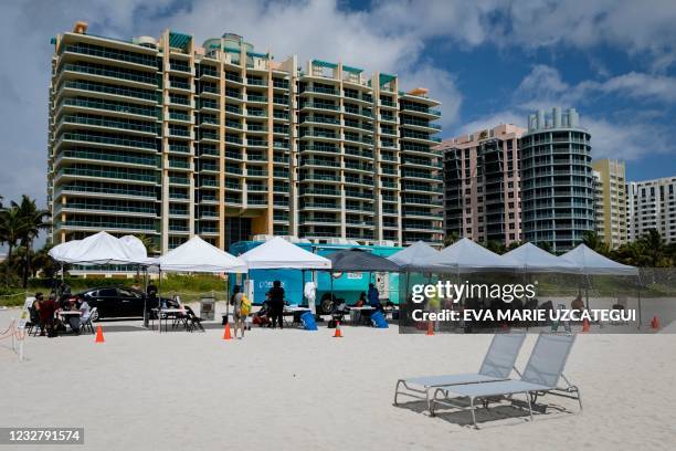 People check in to get a Johnson & Johnson Covid-19 vaccine at a pop-up vaccination center at the beach, in South Beach, Florida, on May 9, 2021.