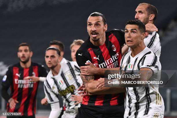 Milan's Swedish forward Zlatan Ibrahimovic and Juventus' Portuguese forward Cristiano Ronaldo eye the ball during the Italian Serie A football match...