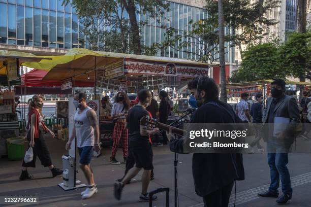 Musician wearing a protective mask performs on Paulista Avenue in Sao Paulo, Brazil, on Sunday, May 9, 2021. The state of Sao Paulo will remain for...