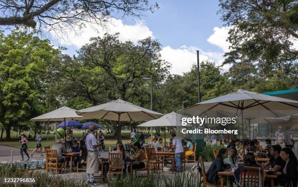 People dine at an outdoor restaurant at Ibirapuera Park in Sao Paulo, Brazil, on Sunday, May 9, 2021. The state of Sao Paulo will remain for another...