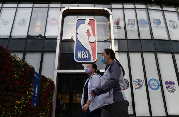 Pedestrians pass in front of the NBA flagship store at Wangfujing Pedestrian Street in Beijing, China, May 10, 2021.