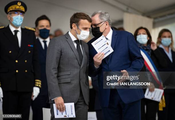 French President Emmanuel Macron speaks with President of the French National Assembly Richard Ferrand, during a ceremony at the Luxembourg Gardens...