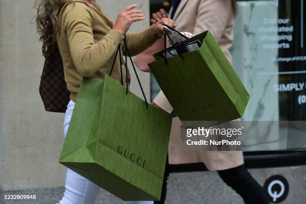 Woman carries shopping bags on Grafton Street in Dublin. After five months of strict lockdown, the first stage of defrosting the Irish economy and...