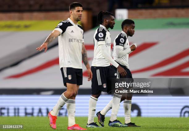 Aleksandar Mitrovic, Andre-Frank Zambo Anguissa and Ademola Lookman of Fulham react after relegation during the Premier League match between Fulham...