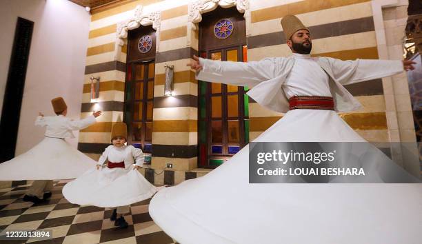 Sufi Dervish dancers Yasser, Anas, and Muayad al-Kharrat, members of the Kharrat family, dance at a restaurant in the Shahgur district of the old...