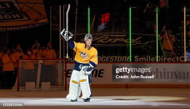 Pekka Rinne of the Nashville Predators is celebrated by his teammates and fans after a 5-0 win against the Carolina Hurricanes at Bridgestone Arena...