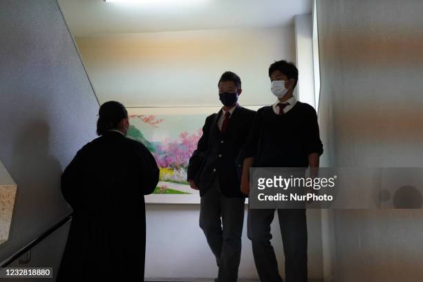Painting of a spring Pyongyang scenery hang on a wall as two schoolboys encounter a schoolgirl in the stairs at Hiroshima Korean School on May 9,...