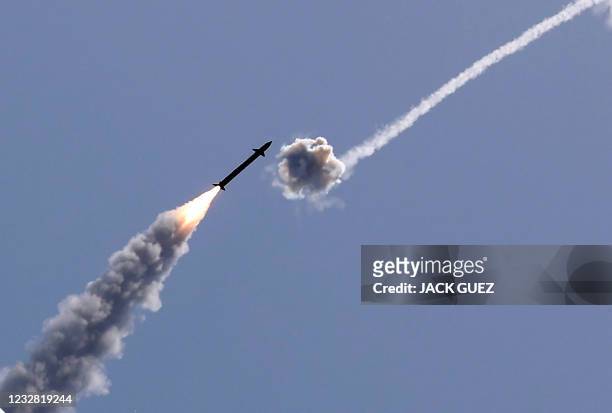 Israel's Iron Dome aerial defence system intercepts a rocket launched from the Gaza Strip, controlled by the Palestinian Hamas movement, above the...