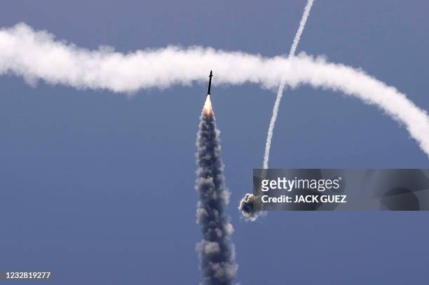 Israel's Iron Dome aerial defence system intercepts a rocket launched from the Gaza Strip, controlled by the Palestinian Hamas movement, above the...