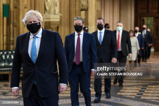 Britain's Prime Minister Boris Johnson and Britain's main opposition Labour Party leader Keir Starmer , both wearing face coverings, lead MPs in a...