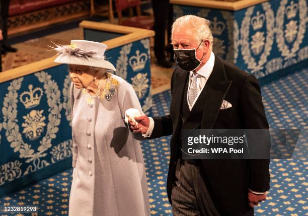 Queen Elizabeth II follows the imperial state crown along the royal gallery, whilst being escorted by Prince Charles, Prince of Wales during the...