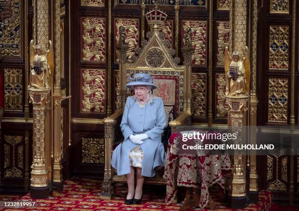 Britain's Queen Elizabeth II waits to read the Queen's Speech on the The Sovereign's Throne in the House of Lords chamber, during the State Opening...