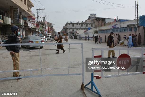 Policemen stand guard on a blocked street in a closed commercial area during a nine-day nationwide shutdown affecting travel and tourist hotspots in...