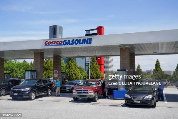 Consumers pump gas at a Costco gasoline station on May 11 in Atlanta, Georgia. - Fears the shutdown of a major fuel pipeline would cause a gasoline...