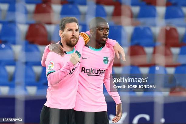 Barcelona's Argentinian forward Lionel Messi celebrates with Barcelona's French forward Ousmane Dembele after scoring during the Spanish league...