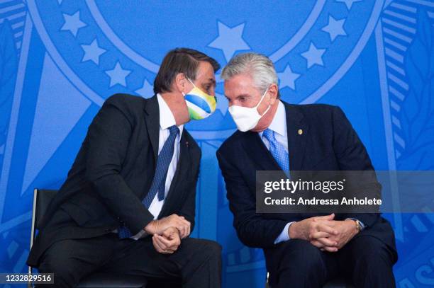 President of Brazil Jair Bolsonaro talks to senator Fernando Collor de Mello during the announcement of a massive acquisition of intubation drugs to...