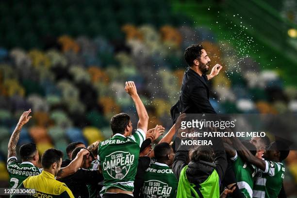 Players toss Sporting's head coach Ruben Amorim after winning the Portuguese League football match against Boavista and the Portuguese League title...