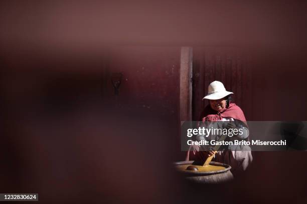 Woman prepares chicha, a traditional beverage of the Andes made from the distillation of corn or other cereals, at Humajila about 10 km from Macha on...