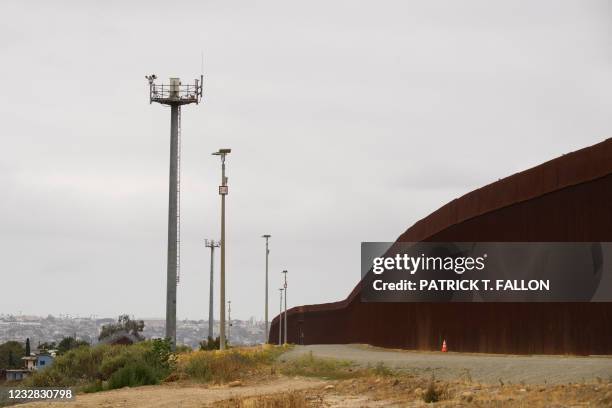 Surveillance towers stand between new sections of the primary and secondary steel bollard-style border wall along the US-Mexico border between San...