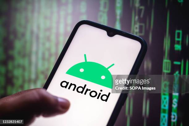 In this photo illustration the Android logo seen displayed on a smartphone screen.