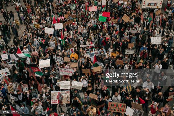 Protesters demanding an end to Israeli aggression against Palestine march in the street in Midtown Manhattan on May 11, 2021 in New York City. Recent...