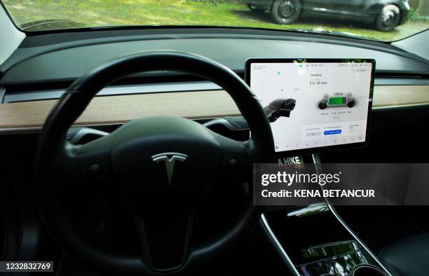 The interior of Ben Richs Tesla vehicle as it charges in his backyard in Montclair, New Jersey on May 06, 2021. - With more electrical models soon...