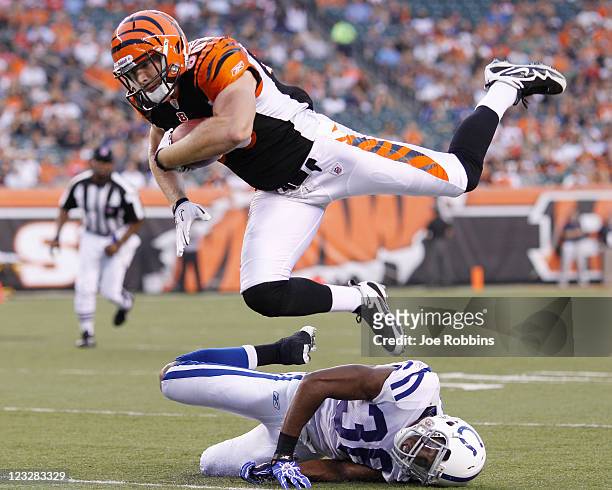 Chase Coffman of the Cincinnati Bengals jumps for a first down over Chris Rucker of the Indianapolis Colts in the first half of an NFL preseason game...