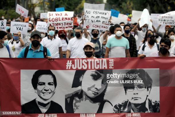 Mexican students hold a sign depicting the siblings Ana Karen, Luis Angel and Jose Alberto Gonzalez during the 'March of Peace and Justice' demanding...