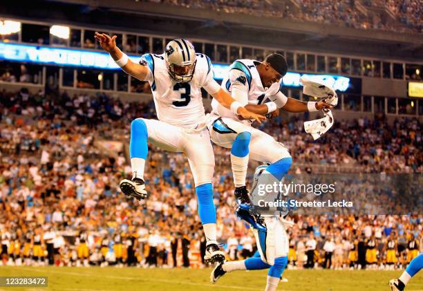 Teammates Derek Anderson and Cam Newton of the Carolina Panthers celebrate after Anderson throws a touchdown against the Pittsburgh Steelers during...