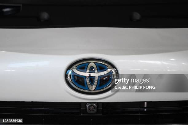 This picture shows a Toyota logo on a car at a closed Toyota showroom in Tokyo on May 12, 2021.