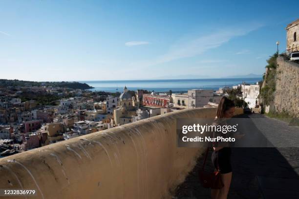 Tourist check her phone during a visit to the Procida Island. Procida, a small island near Naples, is the first Covid free island in Italy, since all...