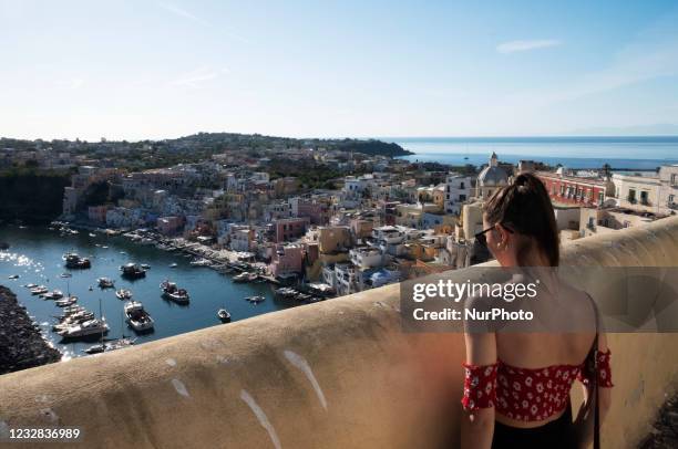 Tourist watches over Marina Corricella, a small port located into Procida Island. Procida, a small island near Naples, is the first Covid free island...