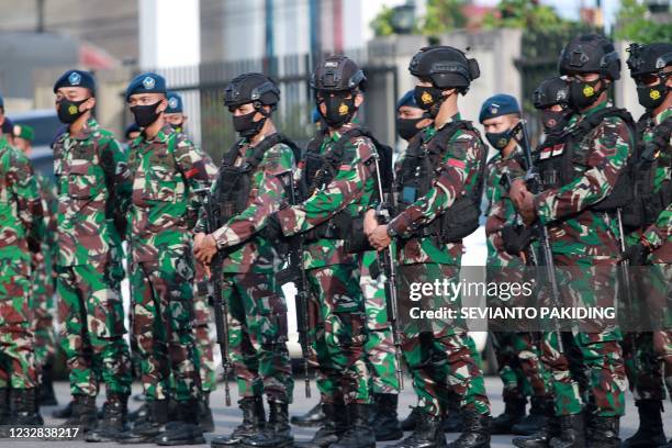 Indonesian soldiers take part in preparations to boost security on the eve of Eid al-Fitr in Timika, Papua on May 12 as Muslims mark the end of the...