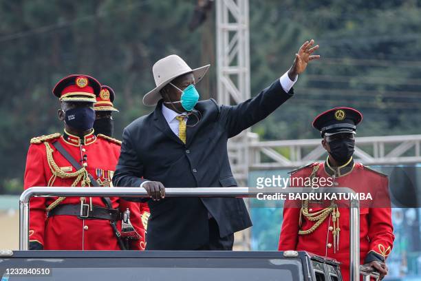 Ugandan President Yoweri Museveni gestures while standing on a car during the inauguration ceremony for his sixth term at Kololo Ceremonial Grounds...