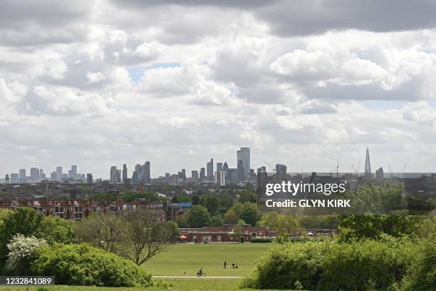 The London skyline is pictured from Hampstead Heath in London on May 12, 2021. - Britain's economy began to recover strongly at the end of the first...