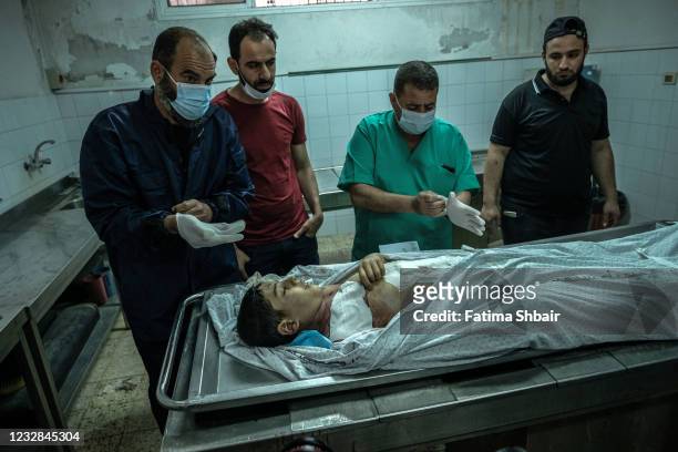 The body of the child Ali Nassar who was killed during an Israeli raid in central Gaza City on May 12, 2021 in Gaza City, Gaza. At least three dozen...